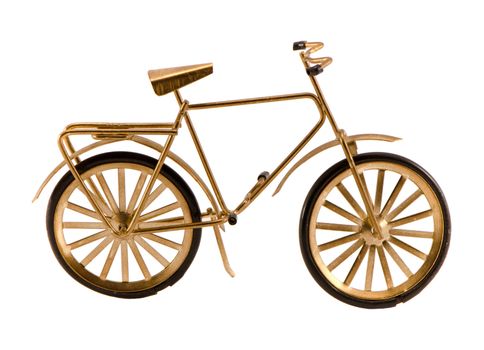 Small gold color toy bicycle isolated on white background.