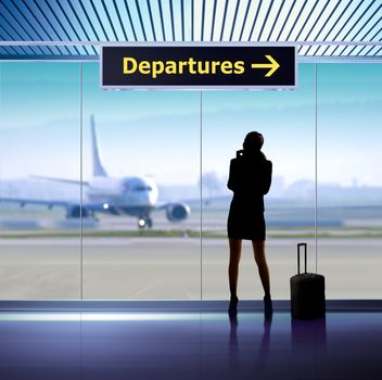 tourist info signage in airport and silhouette of passenger