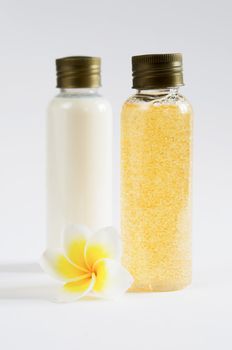  two bottle and  fresh frangipani  on white background