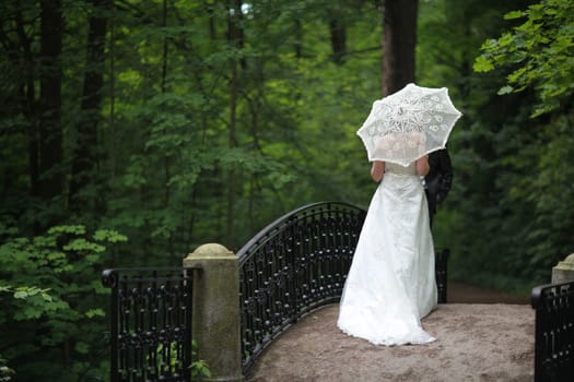 Romantic date, women and men on the bridge in a secluded a corner