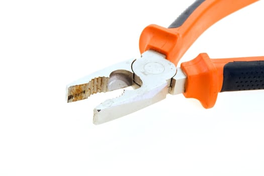 Steel used pliers with plastic color handles on a white background