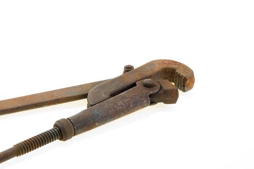 Big used rusty wrench on white background.