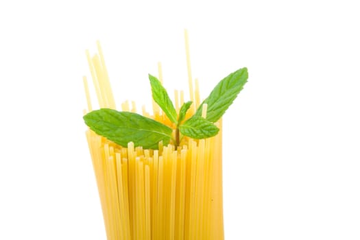 Golden raw dried Italian pasta with other ingredients on white background.