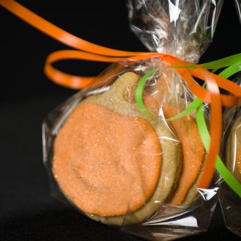 Homemade pumkin cookies on isolated black background.