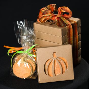 Homemade pumkin cookies on isolated black background.