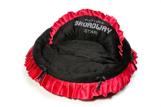 Red and black dog bed isolated on white background.