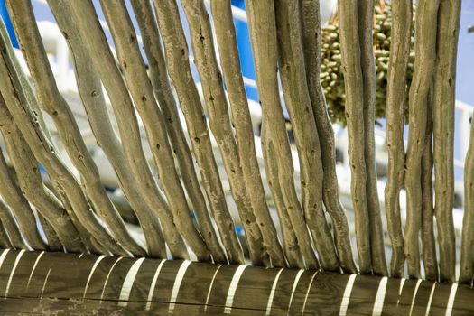 Stylized wooden pergola roof against the blue sky is visible through the roof structure pergolas