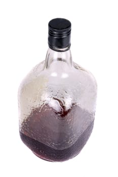 A bottle of dark rum, on white studio background.