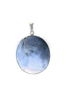 A silver pendant with a beautiful design of the craters of a moon, on white studio background.