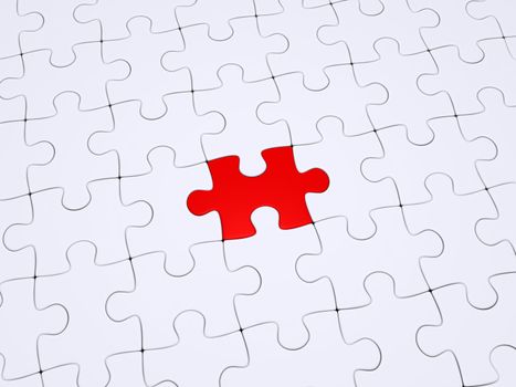 One red puzzle piece amongst white ones