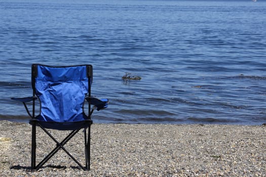 Blue chair on the beach.