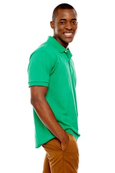 Side view portrait of smiling casual african guy posing with hands in pocket