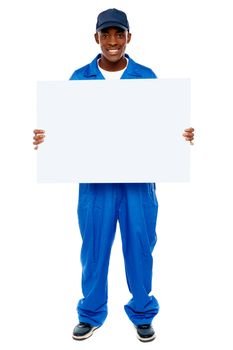 Courier guy presenting blank white billboard, full length portrait