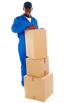 Cheerful delivery guy preparing receiving notice. Isolated over white