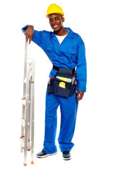 Full length portrait of smiling african worker resting hand on stepladder