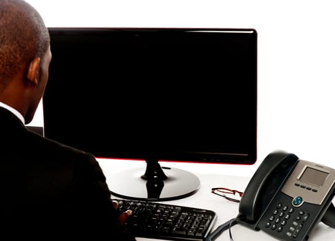 Cropped image of male executive working on pc isolated over white