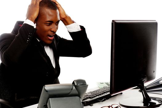 Irritated african man angry on computer at work