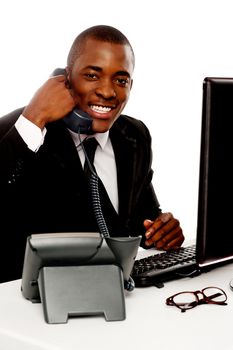 Cheerful young african talking on telephone against white background