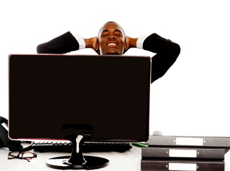 Young african businessman relaxing with hands behind head