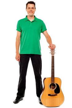 Young guitarist standing with guitar isolated on white background