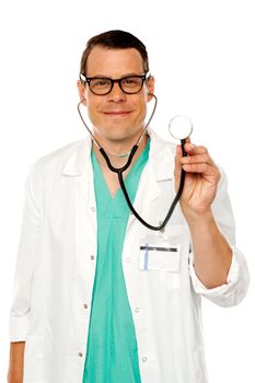 Time for regular checkup. Male doctor with stethoscope in front of camera