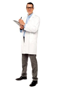 Young physician writing medical report isolated against white background