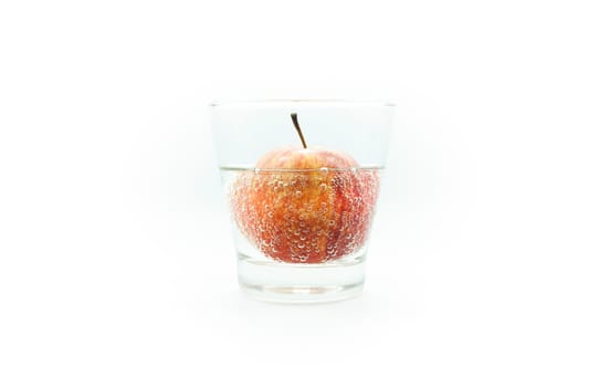 Apple in soda water in glass isolate on white background