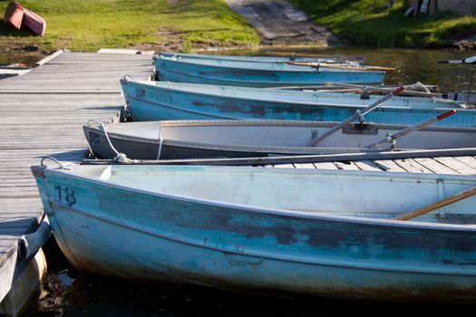 Boats tied to a dock at the lake.