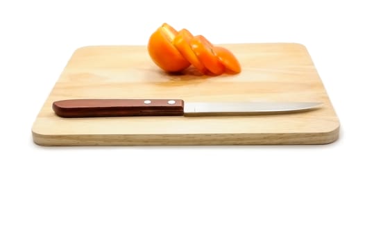 Tomato slice and knife on cutting board isolated on a white background