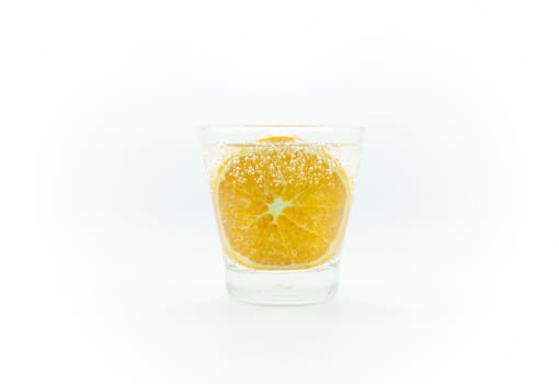 Orange slice in soda water in glass isolate on white background