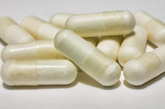 Bunch of capsules of medicine on white background