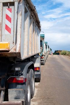 Row of Dump Trucks and Earth Moving Equipment at a Highway Construction Site in Germany