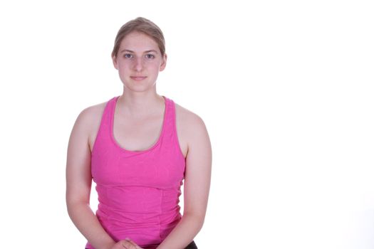 A pretty young woman in work  out clothes, smiling.  There is a white background and copy space.