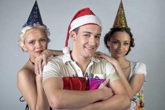 The company of young, beautiful and successful people preparing to celebrate Christmas