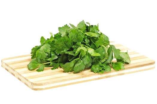Green celery bunch on a cutting board isolated on a white background.