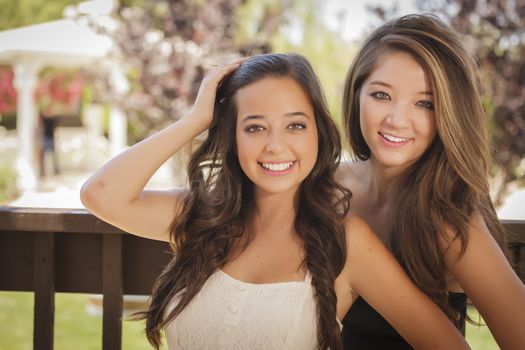 Two Attractive Mixed Race Girlfriends Smile Outdoors.