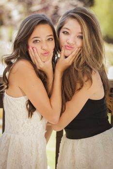 Two Attractive Mixed Race Girlfriends Smile Outdoors.