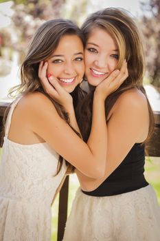 Two Attractive Mixed Race Girlfriends Smile Outdoors.