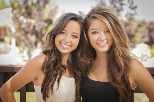Two Attractive Mixed Race Girlfriends Smile Outdoors.