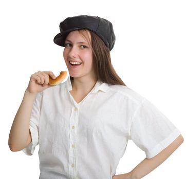 Portrait of a naughty girl in a cap with a bagel in his hand isolated on white background