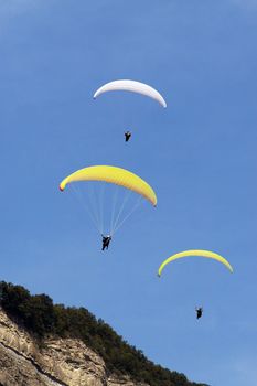 Three para gliders fly in a diagonal line formation