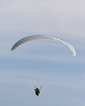 A para glider floating in the air.