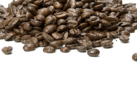 Fresh roasted coffee beans on a white background