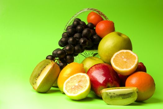 great number of bright and juicy fruit on a green background