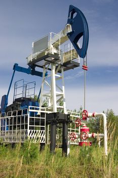 Oil rocking chair of a white-blue coloring on a background of an environment and blue sky