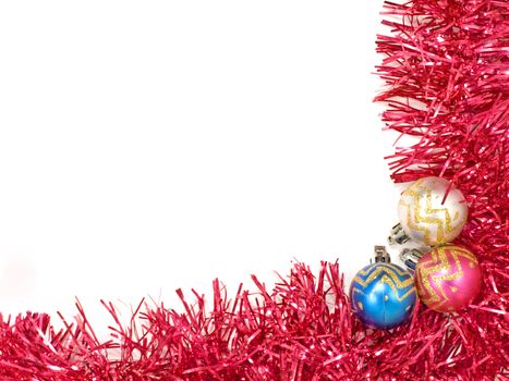 Multicolored christmas balls and red decoration on white background.