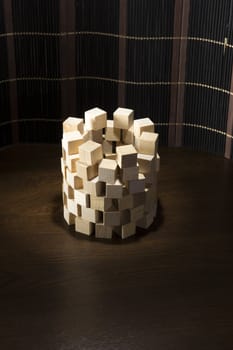 Tower of wooden blocks, built on a wooden surface