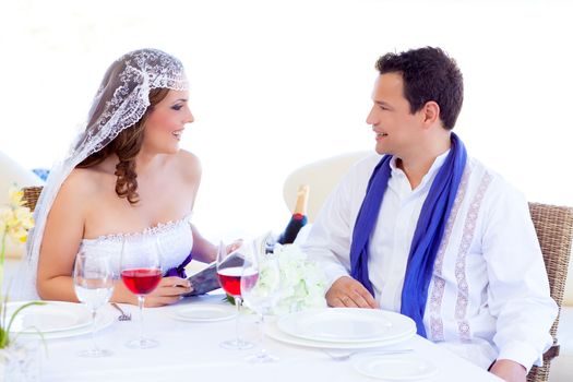 Couple in wedding day with woman reading menu on banquet table