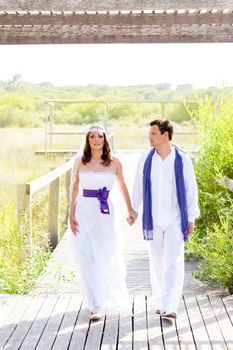 Couple happy in wedding day walking in outdoor deck