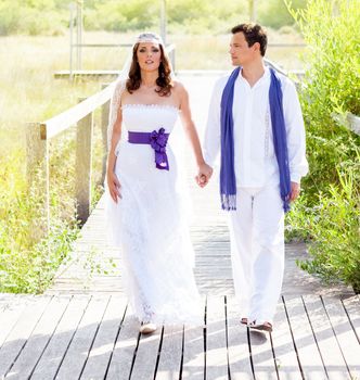 Couple happy in wedding day walking in outdoor deck